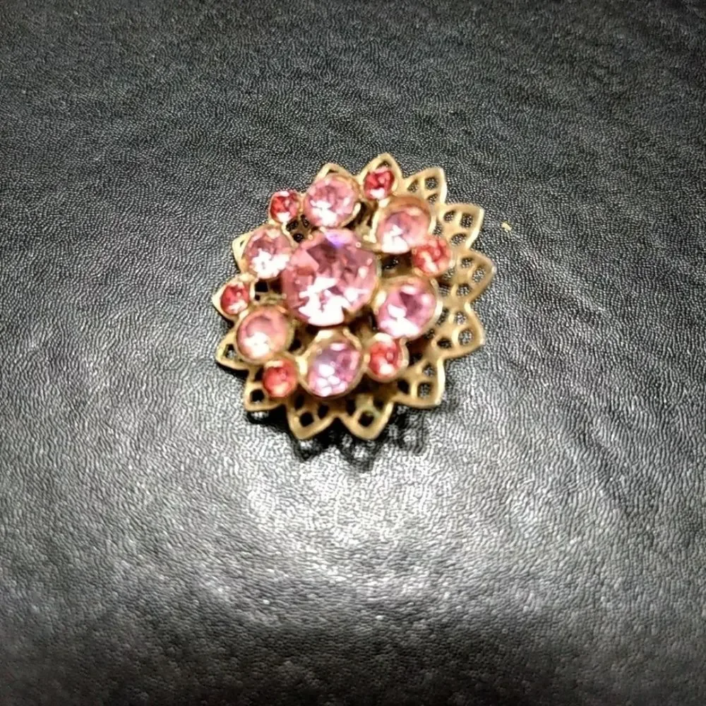 Gold tone flower pin with pink stones brooch